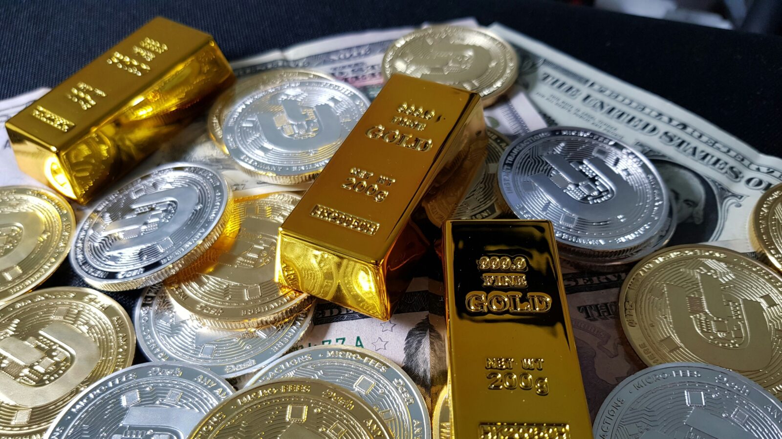 Gold bars and coins representing gold investment rates in India for 24K and 22K gold